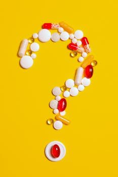 pexels-photo-3683098-3683098 A creative arrangement of various pills forming a question mark against a bright yellow background.